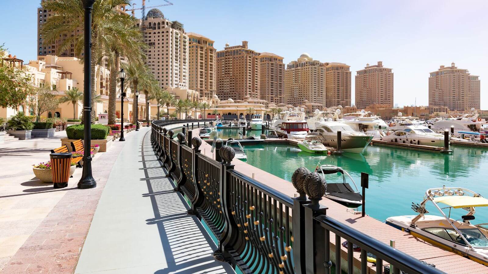 The marina waterfront walkway at the Pearl in Doha, Qatar, with shops and restaurants