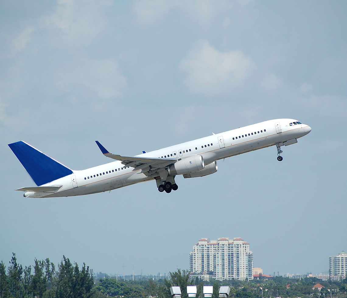 Boeing B757-200 private aircraft charter flight takeoff with city view