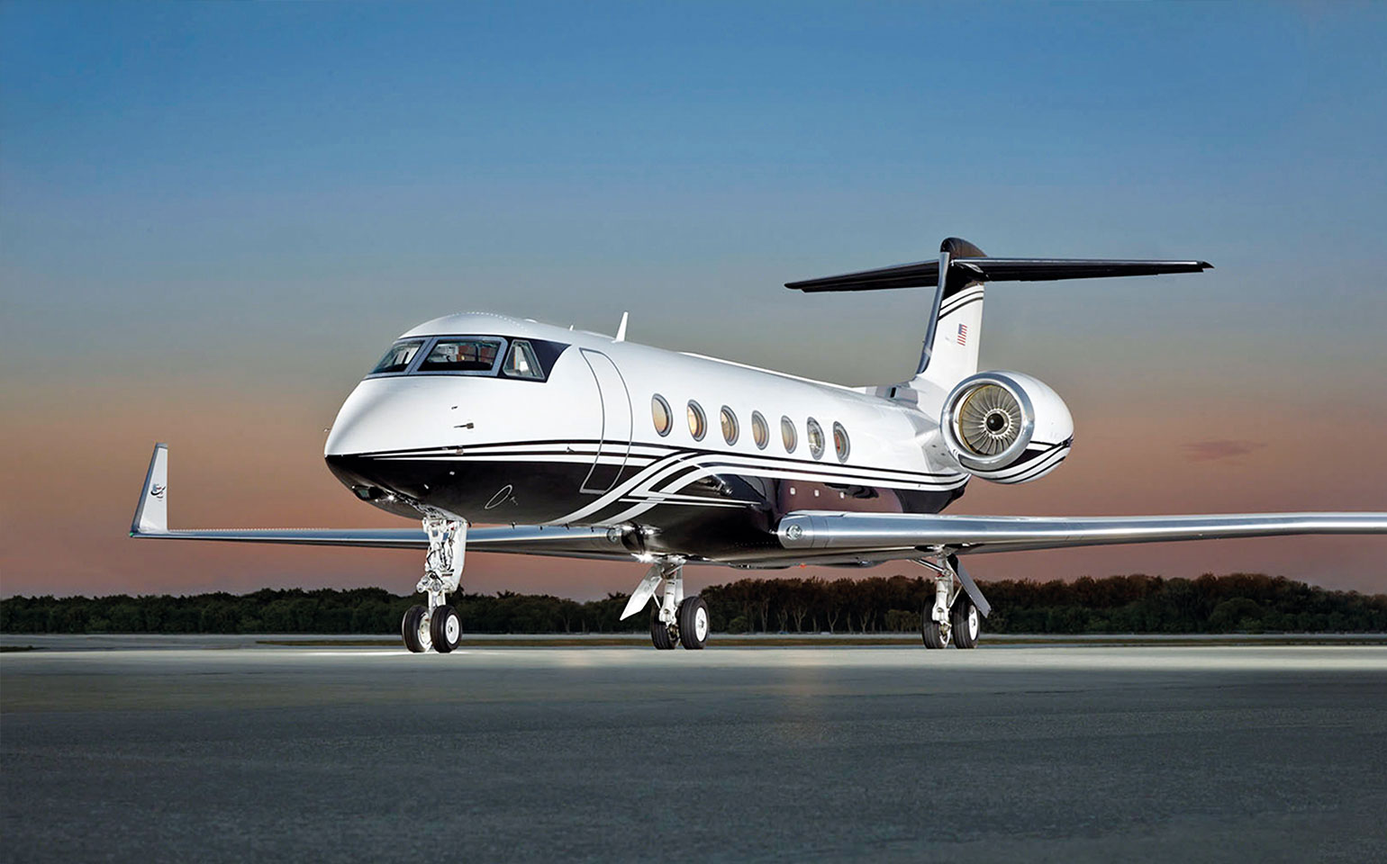 Gulfstream G550 private jet charter on runway during evening