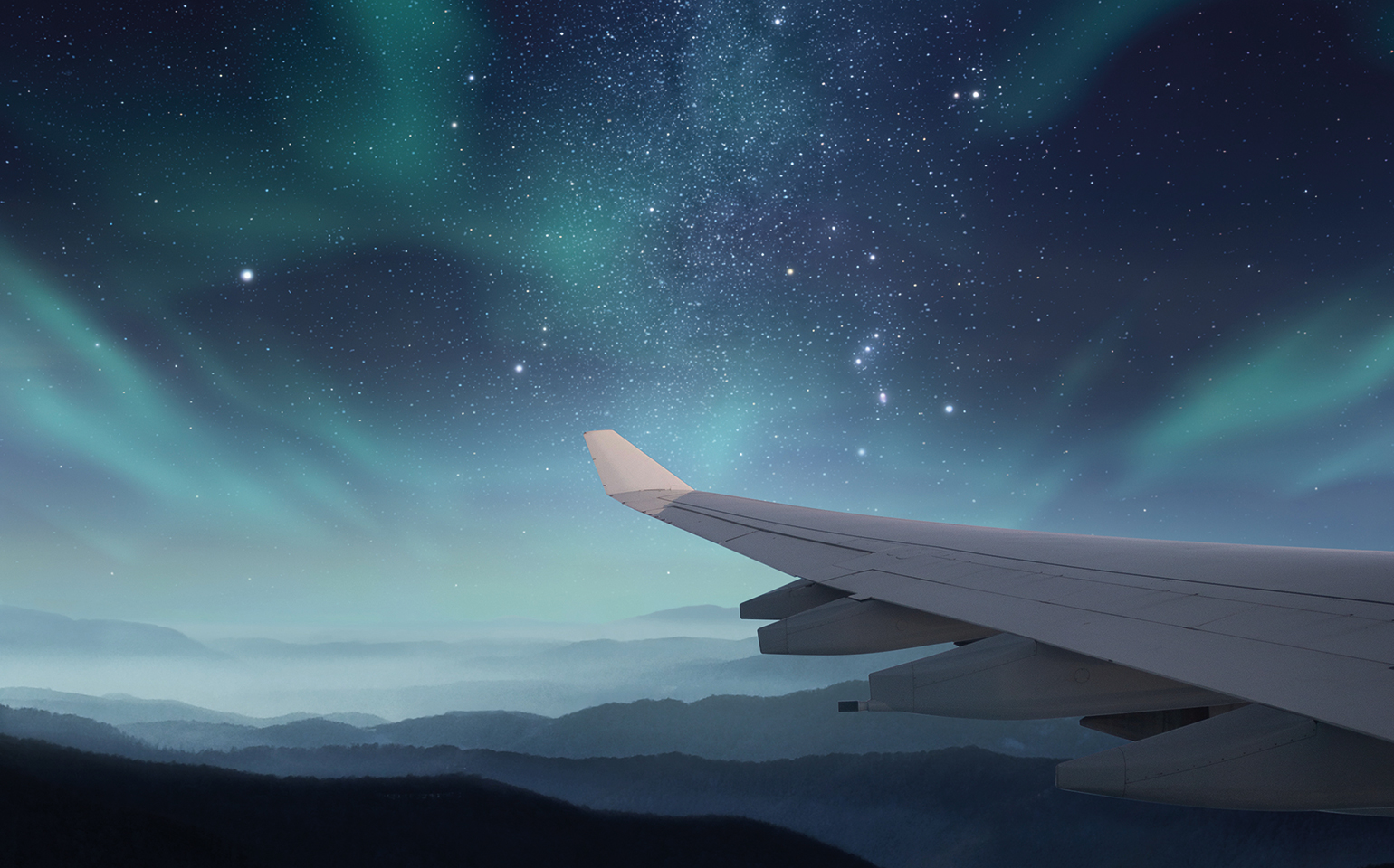 Airplane wing with Northern Lights in view