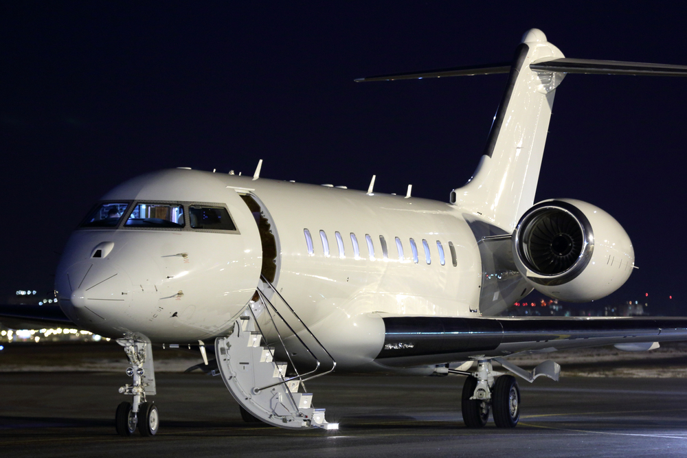 Corporate jet on airport runway at night