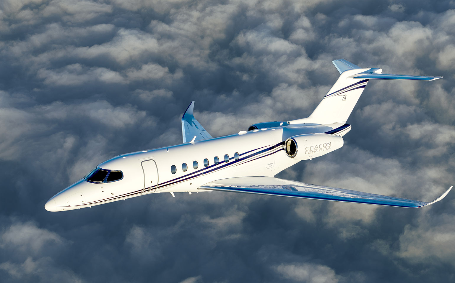 Cessna Citation Longitude private jet charter flight over clouds